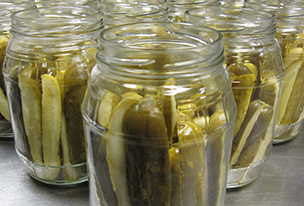Rows of canning jars filled with Bucky's Pickles